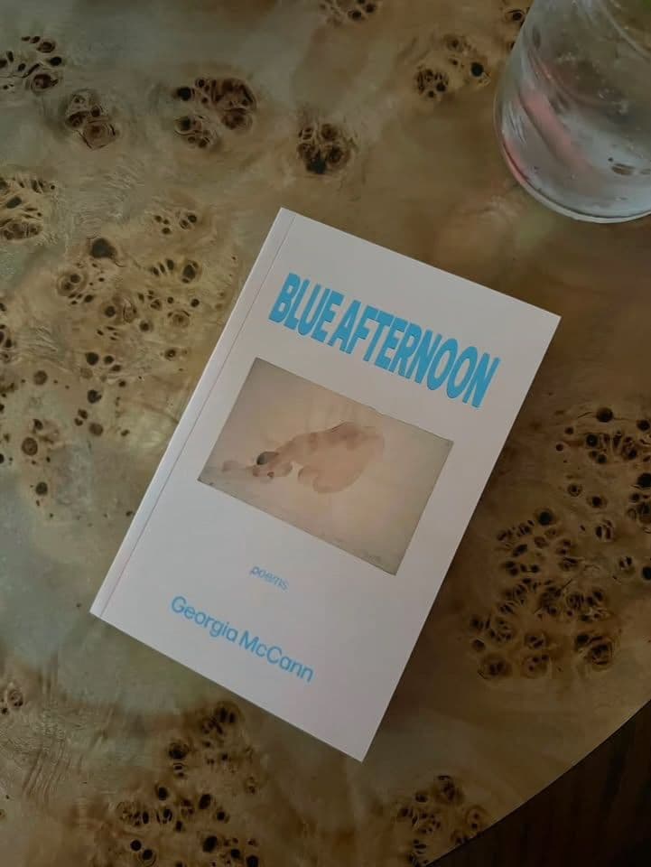Shot of New Gen Nyc's gerogia McCann's debut book of Poetry, "Blue Afternoon" at Moss New York.